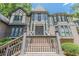 Close-up of the home's impressive front entrance with stairs, custom brickwork, and Tudor details at 5460 Lichenhearth Ct, Stone Mountain, GA 30087