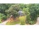 Charming Tudor-style home with lush lawn and mature landscaping at 5460 Lichenhearth Ct, Stone Mountain, GA 30087