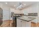 Modern kitchen features white cabinetry, stainless steel appliances, granite counters and wood floors at 5460 Lichenhearth Ct, Stone Mountain, GA 30087
