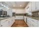 Bright kitchen features granite countertops, stainless steel appliances and white cabinets at 5460 Lichenhearth Ct, Stone Mountain, GA 30087
