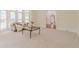 Inviting living room with large windows, neutral carpet, and an arched doorway at 5460 Lichenhearth Ct, Stone Mountain, GA 30087