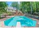 Outdoor pool area with diving board surrounded by lush greenery at 5460 Lichenhearth Ct, Stone Mountain, GA 30087