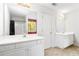 Bright bathroom featuring double sinks, a shower and large window at 5885 Raventree Ct, South Fulton, GA 30349