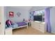 Well-lit bedroom with purple accents, a large window and a television at 5885 Raventree Ct, South Fulton, GA 30349