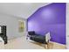Bedroom with a single bed with a black comforter and a purple accent wall at 5885 Raventree Ct, South Fulton, GA 30349