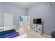 Bedroom with a single bed with a television and an ensuite bath at 5885 Raventree Ct, South Fulton, GA 30349