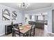 Dining room with modern light fixture, seating for six, adjacent to the living room at 5885 Raventree Ct, South Fulton, GA 30349
