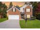Beautiful two-story brick home with a well-manicured lawn and two car garage at 5885 Raventree Ct, South Fulton, GA 30349