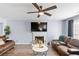 Comfortable living room with a fireplace, hardwood floors and great natural light at 5885 Raventree Ct, South Fulton, GA 30349
