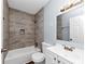 Bathroom featuring textured tile walls, a bathtub, and a vanity sink at 942 Lawton Sw St, Atlanta, GA 30310