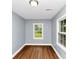 Cozy bedroom with new hardwood floors and natural light from the window at 942 Lawton Sw St, Atlanta, GA 30310
