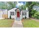 Charming bungalow with a red front door, landscaped yard and a welcoming entrance at 942 Lawton Sw St, Atlanta, GA 30310