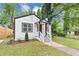 Inviting front exterior with a classic design, fresh landscaping, and a pop of color with the red door at 942 Lawton Sw St, Atlanta, GA 30310