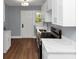 Bright kitchen features white cabinets, wood flooring, and stainless steel appliances at 942 Lawton Sw St, Atlanta, GA 30310