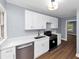 Well-lit kitchen with gray walls, stainless steel appliances, and white cabinetry at 942 Lawton Sw St, Atlanta, GA 30310