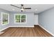 Spacious living room with new floors, large windows, and a modern ceiling fan at 942 Lawton Sw St, Atlanta, GA 30310
