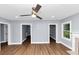 Open-concept living room with hardwood floors, neutral paint, and convenient doorways at 942 Lawton Sw St, Atlanta, GA 30310