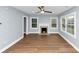 Inviting living area with hardwood floors, fireplace, and ample natural light at 942 Lawton Sw St, Atlanta, GA 30310