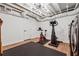 Finished basement with exposed ceiling, drop lighting and workout equipment at 1275 Mayfield Rd, Milton, GA 30009