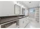 Modern bathroom with dual sinks, gray countertops, and geometric tile in the shower at 1275 Mayfield Rd, Milton, GA 30009