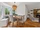 Charming dining area with a bay window, comfortable seating, and view of the fireplace in the living room at 1275 Mayfield Rd, Milton, GA 30009