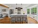 Modern kitchen with a center island, stainless steel appliances, white cabinets, and hardwood flooring at 1275 Mayfield Rd, Milton, GA 30009