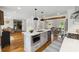 Bright kitchen with a center island, stainless appliances, hardwood floors, and an open floor plan at 1275 Mayfield Rd, Milton, GA 30009