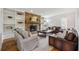 Cozy living room with a stone fireplace, built-in bookshelves, and comfortable seating arrangements at 1275 Mayfield Rd, Milton, GA 30009