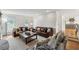 Comfortable living room with hardwood floors, ample seating, and view into kitchen at 1275 Mayfield Rd, Milton, GA 30009