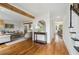 Open-concept design featuring hardwood floors connecting the living room, entryway, and dining area at 1275 Mayfield Rd, Milton, GA 30009
