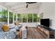 Relaxing sunroom with large windows, comfortable seating, and a ceiling fan at 1275 Mayfield Rd, Milton, GA 30009