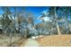 View of exterior with driveway, landscaping, and mature trees, offering a secluded and private setting at 274 Fairburn Nw Rd, Atlanta, GA 30331