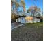 Modest single-story home with boarded windows and overgrown front lawn surrounded by mature trees at 274 Fairburn Nw Rd, Atlanta, GA 30331