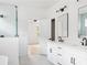 Bright bathroom featuring dual sinks, black fixtures and a glass enclosed shower at 2761 Mathews St, Smyrna, GA 30080