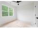 Well-lit bedroom with a ceiling fan and a large window showing lush trees at 2761 Mathews St, Smyrna, GA 30080