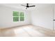Bright bedroom with white walls, ceiling fan, and window overlooking green trees at 2761 Mathews St, Smyrna, GA 30080
