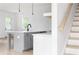 Kitchen island featuring gray cabinets, white countertop and black faucet at 2761 Mathews St, Smyrna, GA 30080