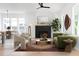 Bright living room with a fireplace, contemporary furnishings, and large windows at 2761 Mathews St, Smyrna, GA 30080