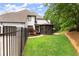 Charming home featuring a well-manicured lawn, a screened-in porch, and beautiful landscaping in the backyard at 725 Danbridge Way, Roswell, GA 30076