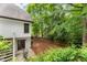 Backyard view with stairs leading to the door, featuring a seating area and lots of trees at 725 Danbridge Way, Roswell, GA 30076