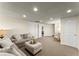 Basement area showcases neutral walls, carpet, and comfortable seating for entertaining at 725 Danbridge Way, Roswell, GA 30076
