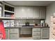 Basement kitchenette area with ample counter space, storage cabinets, and neutral decor at 725 Danbridge Way, Roswell, GA 30076