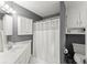 Bathroom featuring gray walls, white cabinets, a shower-tub combo with a white shower curtain at 725 Danbridge Way, Roswell, GA 30076