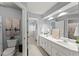 Bathroom with toilet, and a double sink vanity with wall mirror at 725 Danbridge Way, Roswell, GA 30076