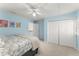 Cozy blue bedroom with carpet flooring, ceiling fan, double door closet, and plenty of natural light at 725 Danbridge Way, Roswell, GA 30076