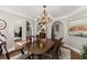 Elegant dining room features a chandelier, a large wooden table, and stylish decor at 725 Danbridge Way, Roswell, GA 30076