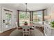 Bright dining area with a round table, large windows, and access to the outside at 725 Danbridge Way, Roswell, GA 30076