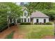 Beautiful two-story home with a lush green lawn and manicured landscaping at 725 Danbridge Way, Roswell, GA 30076
