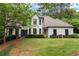 Beautiful home featuring a large lawn and mature trees at 725 Danbridge Way, Roswell, GA 30076