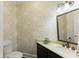 Charming half bath featuring stylish wallpaper, a modern vanity, and updated fixtures at 725 Danbridge Way, Roswell, GA 30076